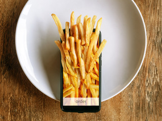 Ordering and delivery of food through the mobile application. Fast food, french fries.