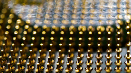 A macro shot of water flooding between the gold pins of an old computer processor.