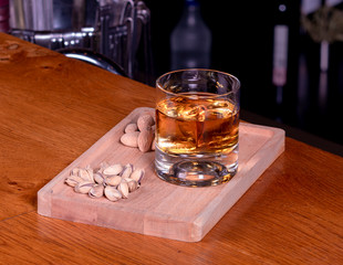 Glass of whiskey and nuts