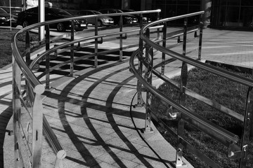 shiny metal or iron staircase and granite stone path in the city