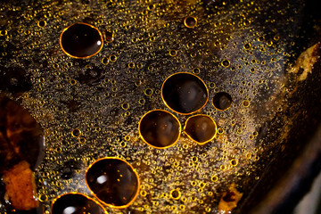 stains and bubbles of fat in water, circles and dots of orange, yellow, golden color, contrasting...