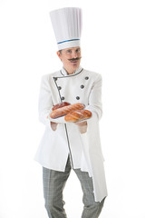 Cook in white uniform holds a bread on a plate on a white background