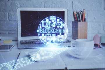 Multi exposure of blockchain and crypto economy theme hologram and table with computer background....