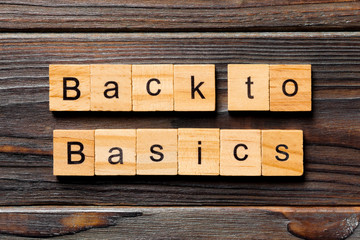 back to basics word written on wood block. back to basics text on table, concept