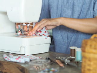 Women sew a surgical mask to protect against viruses and dust.