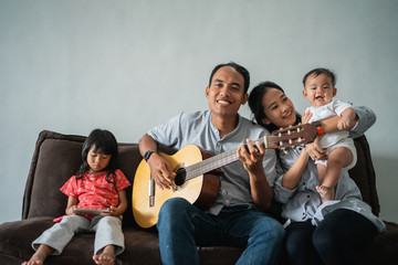 father played the guitar to fill the activities while staying at home, mother and son sang along...