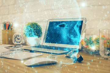 Double exposure of work space with computer and human brain drawing hologram. Brainstorm concept.