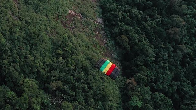 Aerial View Of Paraglider Gliding Over Lush Green Forest In Rio De Janeiro