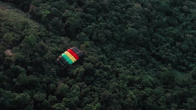 Aerial View Of Parachuter Gliding Over Lush Green Forest In Rio De Janeiro