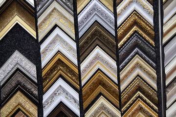 Picture frames samples in a workshop. Colorful samples of picture frames molding