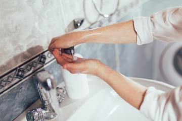 Boy washing his hands in bathroom. Protection against viruses and bacteria. Close up.