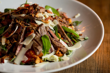 Beefsteak salad with lettuce, rocket,  and spinach with parmesan and .homemade spicy croutons