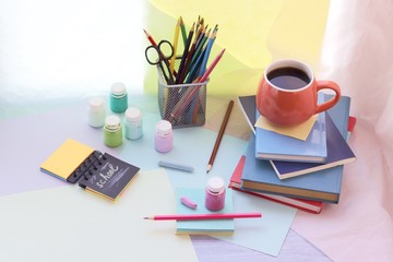 School stationery, books, cup of tea on the table, home schooling concept, part of the interior children's room, back to school