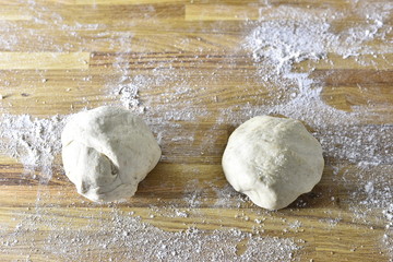 Fresh bread dough on a wood background