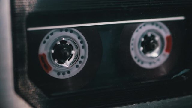Tape Recorder Plays Transparent Audio Cassette. Vintage Audio Cassette Rotates