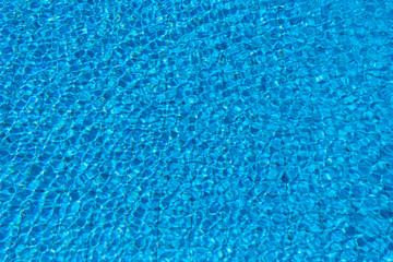 Fototapeta na wymiar Pure Blue Water In The Swimming Pool. Ripple And Waves In Clear Turquoise Water. Glare And Reflection, Water Pool Surface Background. Aqua Texture, Backdrop.