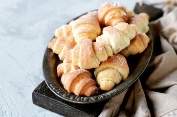 Bagels of cottage cheese on a metal vintage platter on a gray background