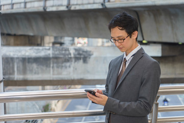 Middle aged businessman is using smartphone.