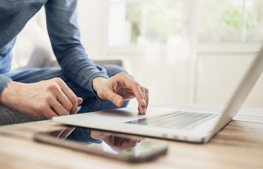 Young man working from home. Men student using laptop. Freelance, businessman, student lifestyle, distance education, technology, entrepreneur and online shopping concept