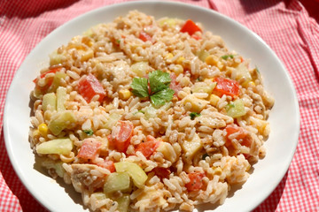 Salad with rice, chicken, cheese and vegetables. Selective focus.