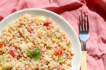 Salad with rice, chicken, cheese and vegetables. Top view.
