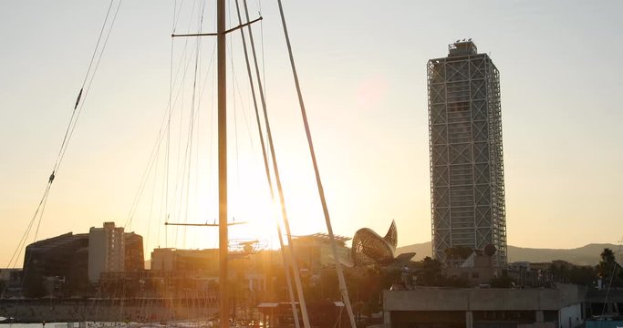 Sailboat and tower with sushine in port of barcelona