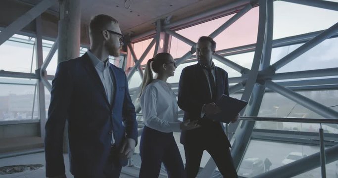 Engineer, businessman and architect examining construction site