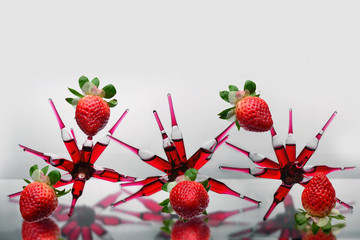 Glass ampoules with a red b 12 vitamine medicine glued together in a three spider shape...
