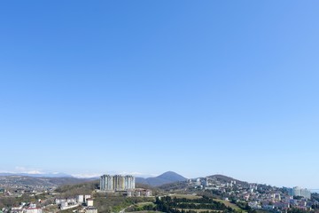 Fototapeta na wymiar top view of the spring panorama of the southern city with sea and mountain horizon