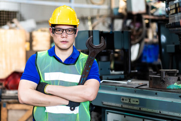 Portrait Asian engineering man in an industrial Manufacturing facility.