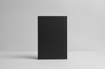 Black Hardcover Book Mock-Up - Backside. Wall Background