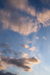 Cloudy sunset sky with blues, pink and orange