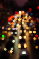 Blurred footage. Traffic jam on a wide street. Blurry brake lights. Dense city traffic. Transport interchange. Night footage.