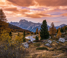 Overcast morning autumn alpine Dolomites mountain scene. Peaceful view near Valparola and Falzarego Path, Belluno, Italy.