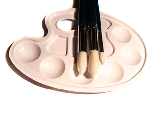 Paintbrushes on Palette isolated on white 