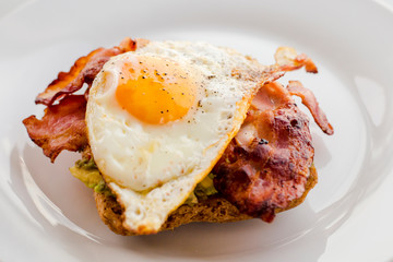 close up of avocado toast for breakfast with fried egg