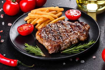 Ribeye steak with potatoes, onions and cherry tomatoes