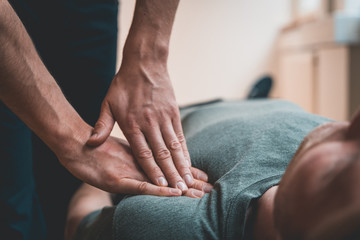 Physiotherapist treating patient for various physical ailments and giving shoulder a massage
