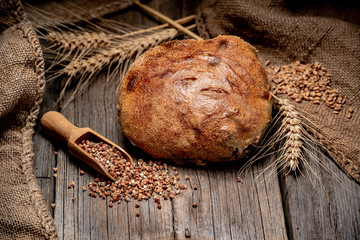 Freshly baked traditional bread on wooden table.