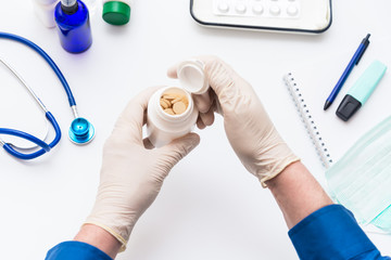 Fototapeta premium A man takes medications and vitamins, prevention and treatment of coronavirus