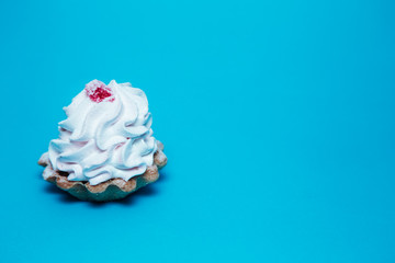 Tartlets with lemon juice and red marmalade on top on a blue background. confectionery product. concept.