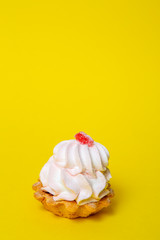 Tartlets with lemon juice and red marmalade on top on a yellow background. confectionery product.