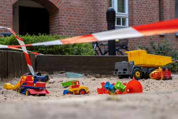 Corona crisis - Children's playground cordoned off with a red and white barrier tape in the...