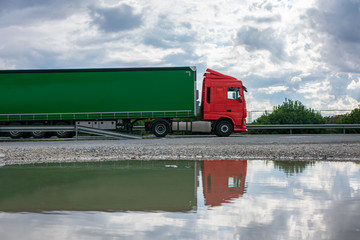 Truck with canvas semi-trailer with side opening for general transport while driving on the highway