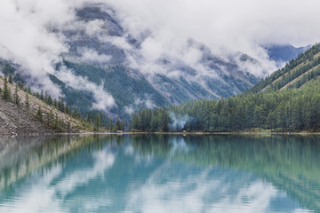 Fototapeta premium misty lake with blue water in the mountains