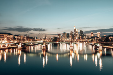 sunset over Frankfurt skyline, reflection in main river