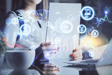 Double exposure of hands making notes with forex chart huds. Stock market concept.