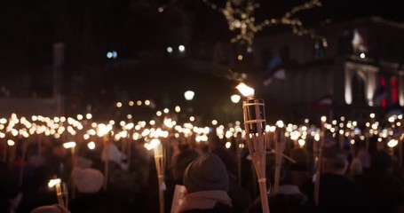 Torchlight procession march at night people protest with burning torches