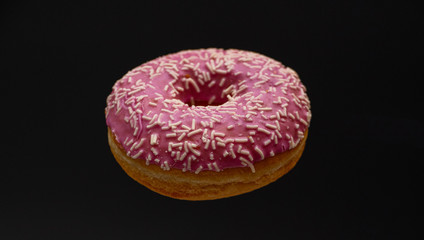 Donut - close up of a pink doughnut - food photography