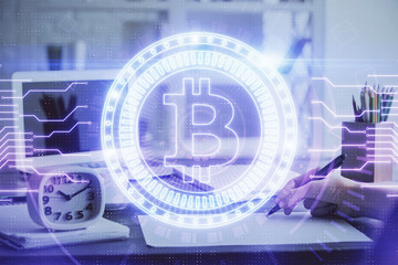 Cryptocurrency hologram over hands taking notes background. Concept of blockchain. Multi exposure